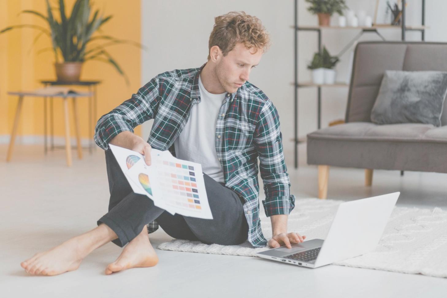 Modern office workspace with financial documents and laptop displaying spreadsheet data
